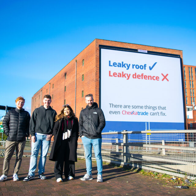 Checkatrade billboard in Manchester with c3 team stood outside